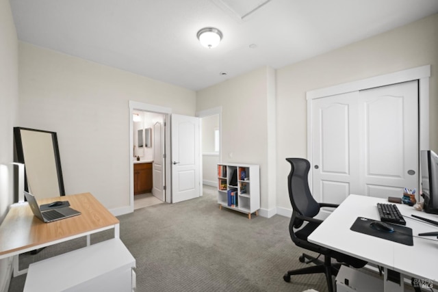 carpeted office featuring baseboards