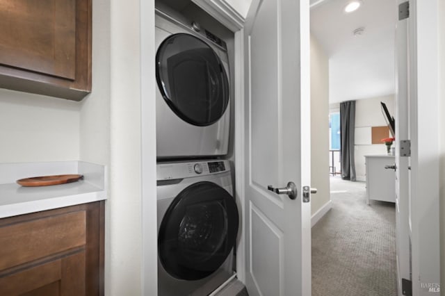 washroom featuring light carpet, laundry area, stacked washer / dryer, and recessed lighting