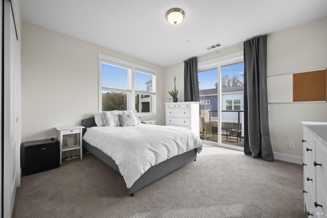 carpeted bedroom featuring access to outside, visible vents, and baseboards