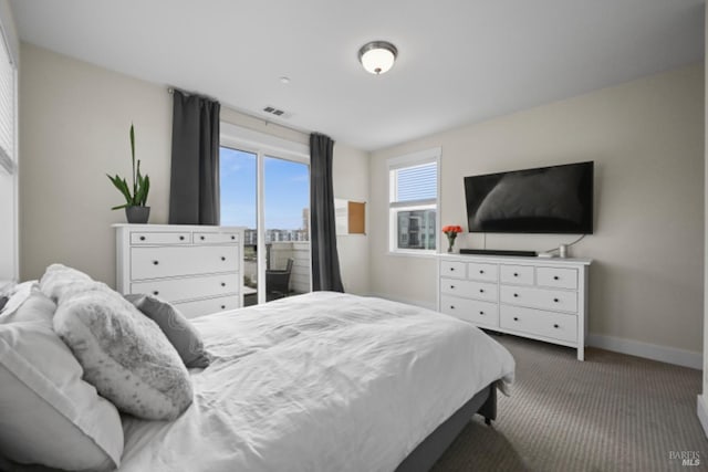 bedroom with dark colored carpet and baseboards