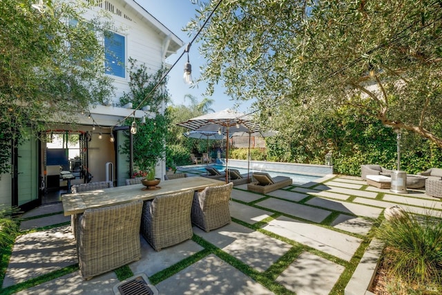 view of patio / terrace with an outdoor pool, outdoor lounge area, and outdoor dining space