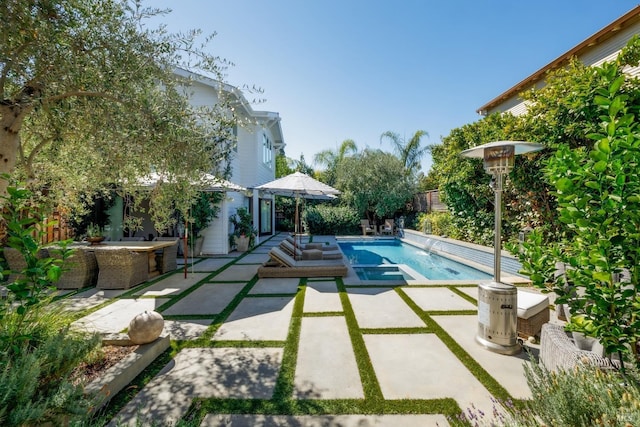 outdoor pool featuring a fenced backyard and a patio