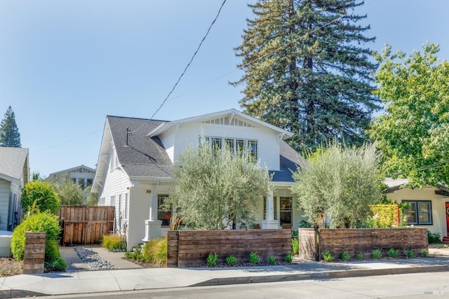 view of front of house with roof with shingles and a fenced front yard