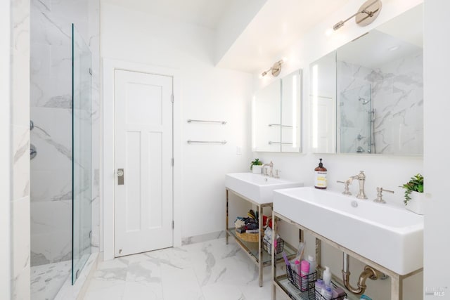 full bath featuring marble finish floor, a sink, and a marble finish shower