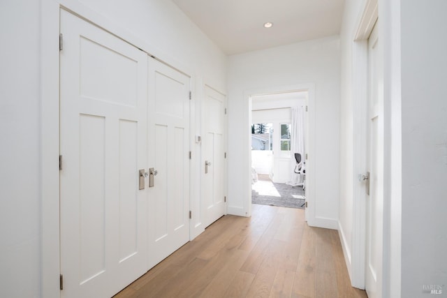 hallway with light wood-style floors, recessed lighting, and baseboards