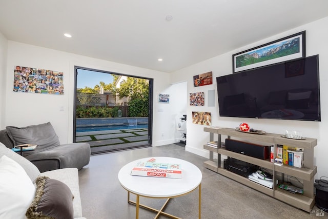 living area with baseboards and recessed lighting