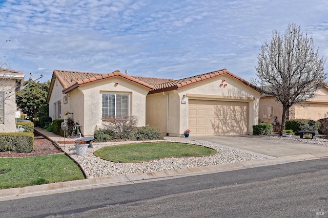 mediterranean / spanish-style home featuring a tile roof, driveway, an attached garage, and stucco siding