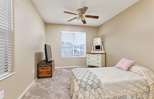 bedroom featuring light carpet, baseboards, and a ceiling fan