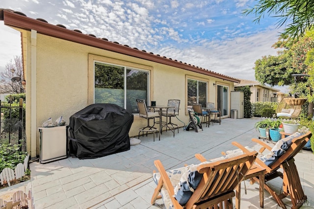 view of patio / terrace featuring fence, outdoor dining area, and area for grilling