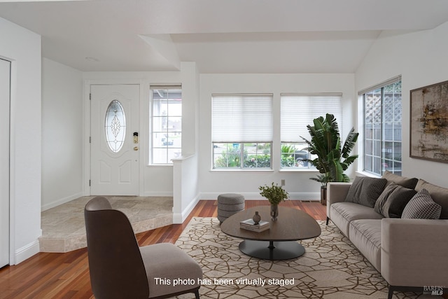 living area with wood finished floors and baseboards