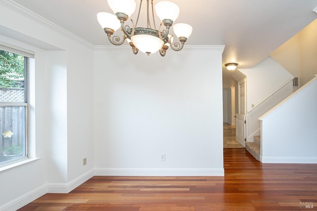 unfurnished dining area with baseboards, visible vents, stairway, wood finished floors, and an inviting chandelier