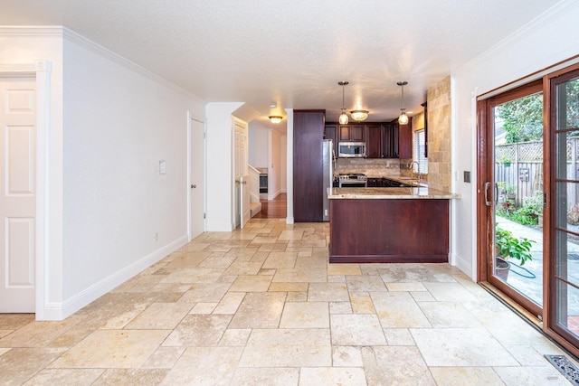 kitchen with tasteful backsplash, baseboards, appliances with stainless steel finishes, a peninsula, and stone tile flooring