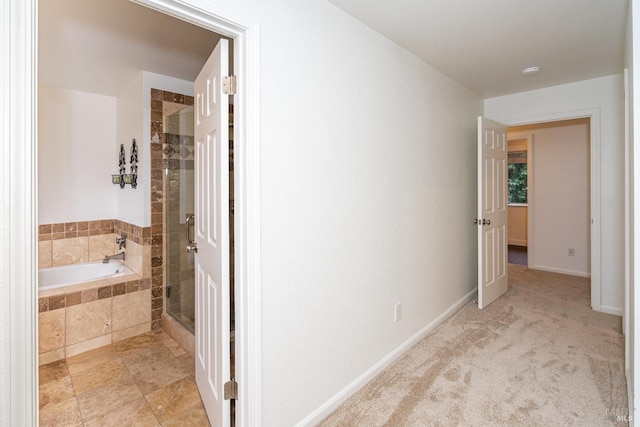 full bathroom featuring a shower stall, baseboards, and a bath