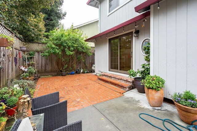 view of patio featuring entry steps and fence