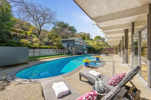 view of swimming pool with a fenced in pool, a patio area, an outdoor structure, and a fenced backyard