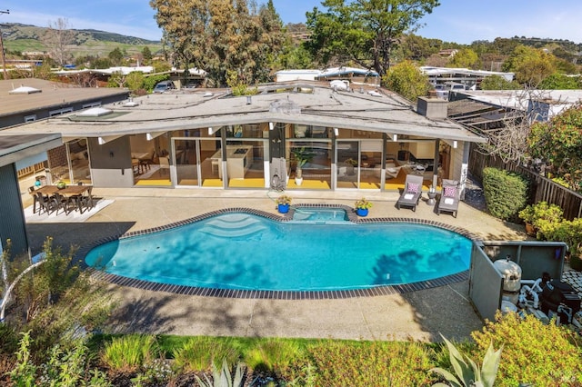 view of pool featuring a patio area and a pool with connected hot tub