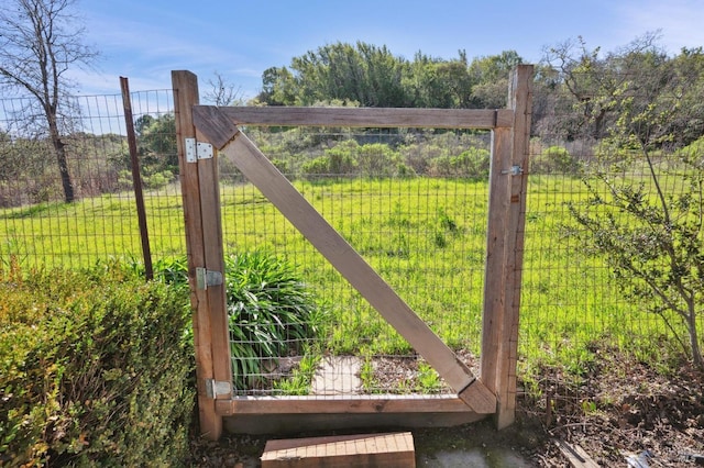 view of gate with a garden and fence