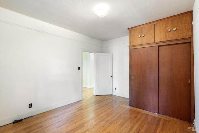 unfurnished bedroom with light wood finished floors and baseboards