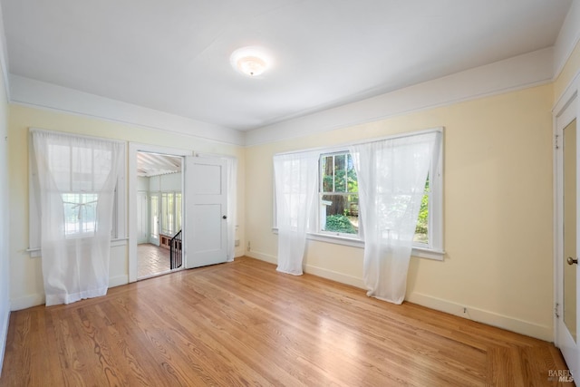 unfurnished room featuring light wood-style floors and baseboards