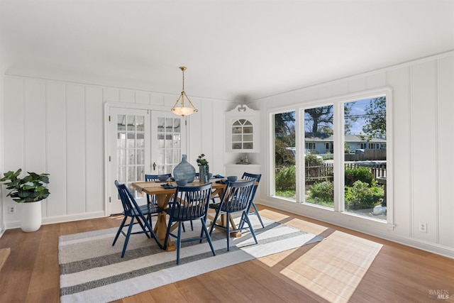 dining room featuring a decorative wall and wood finished floors