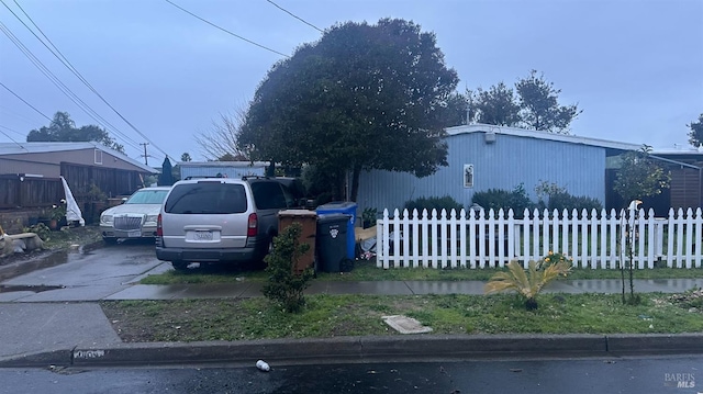 view of front of home featuring fence