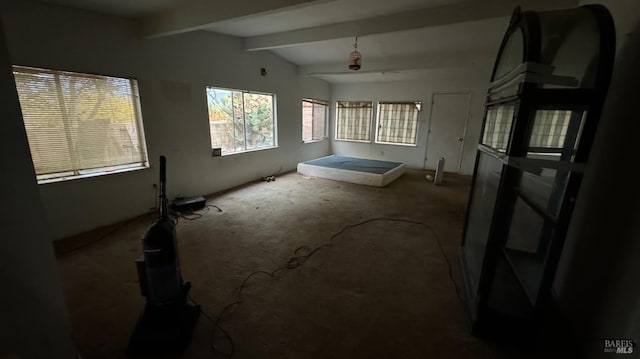 interior space featuring vaulted ceiling with beams