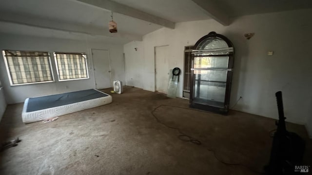 miscellaneous room with vaulted ceiling with beams