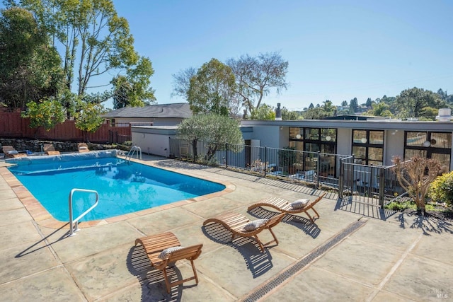 view of pool featuring a patio area, fence, and a fenced in pool