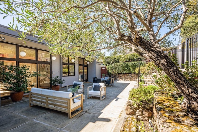 view of patio featuring fence and an outdoor hangout area