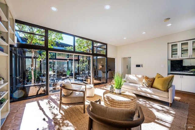 living room featuring floor to ceiling windows and recessed lighting