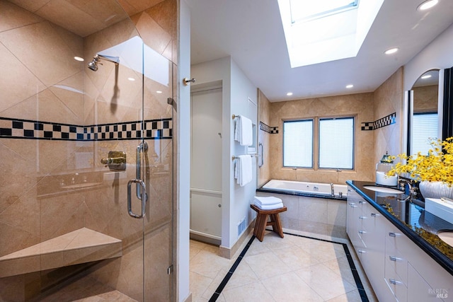 full bathroom with a garden tub, recessed lighting, a skylight, a sink, and a shower stall