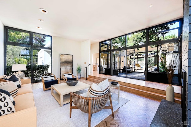 living room with plenty of natural light and expansive windows