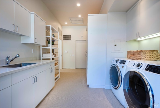 laundry room with recessed lighting, light carpet, separate washer and dryer, a sink, and cabinet space