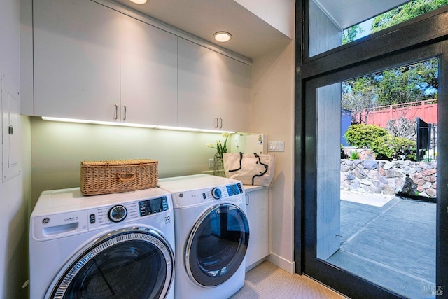 laundry area with cabinet space and washer and clothes dryer