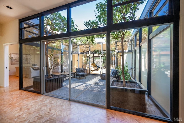 entryway with a towering ceiling and expansive windows