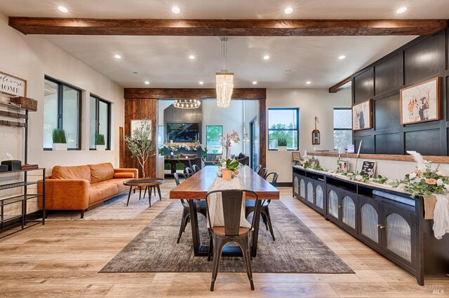 dining area featuring light wood finished floors, beamed ceiling, an inviting chandelier, and recessed lighting