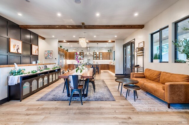 dining area featuring light wood-style floors, recessed lighting, beamed ceiling, and baseboards