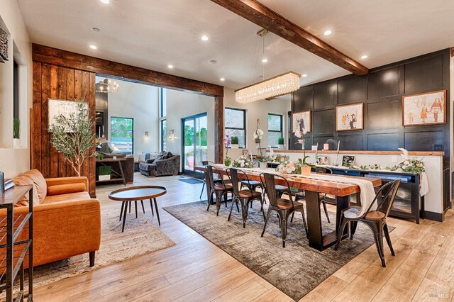 dining area featuring light wood finished floors, beam ceiling, and recessed lighting