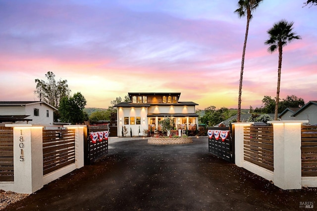 contemporary house with a fenced front yard and a gate