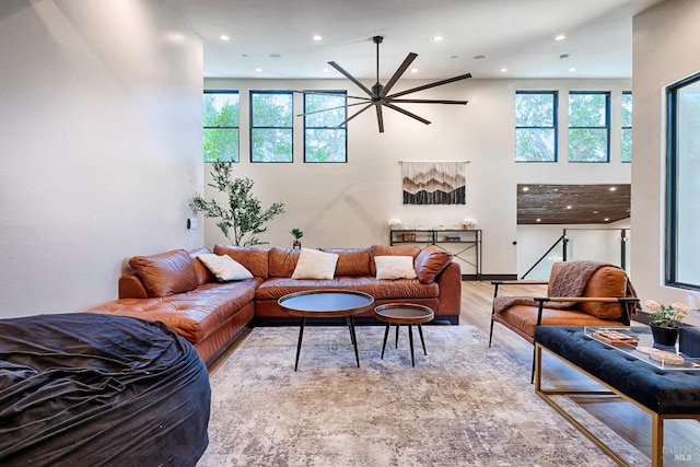 living area with light wood-style floors, a wealth of natural light, and recessed lighting