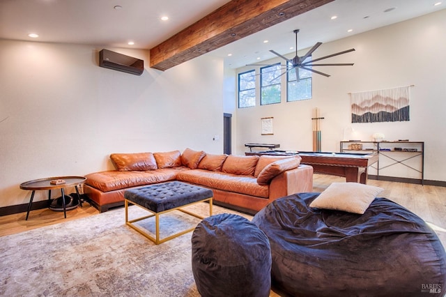 living room featuring light wood-type flooring, recessed lighting, beamed ceiling, and a wall mounted AC