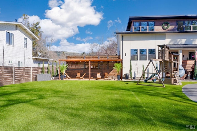 view of yard featuring a playground, fence, and cooling unit