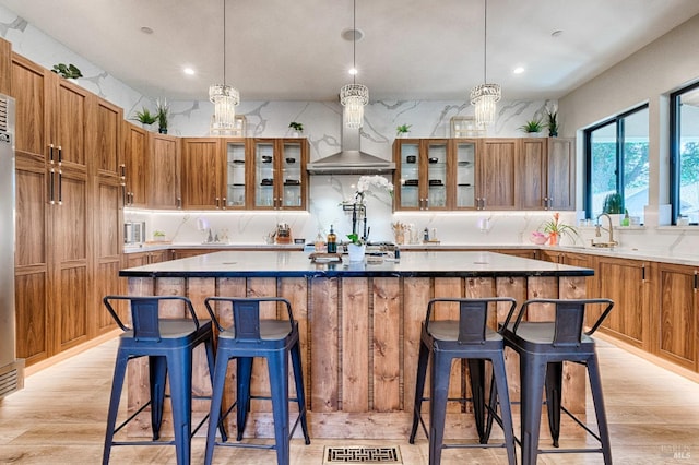 kitchen with glass insert cabinets, light countertops, and a center island