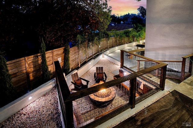 exterior space with an outdoor fire pit and a fenced backyard