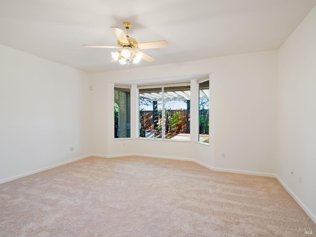 unfurnished room with light carpet, ceiling fan, and baseboards