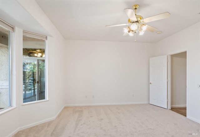 spare room featuring ceiling fan, carpet floors, and baseboards