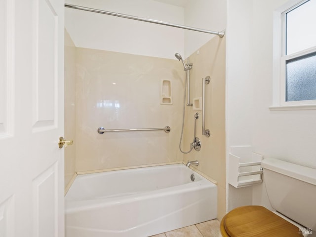 bathroom featuring tub / shower combination, tile patterned flooring, and toilet