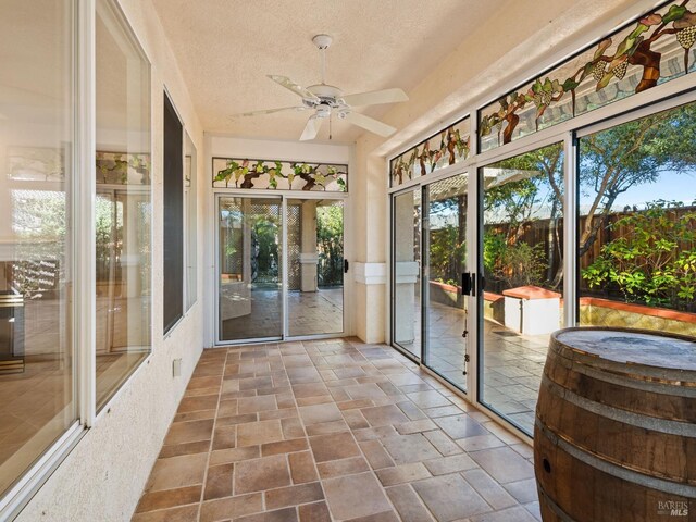 sunroom featuring ceiling fan