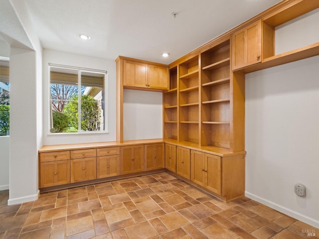 interior space with stone finish flooring, baseboards, and recessed lighting