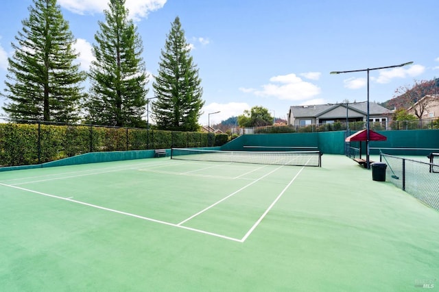 view of sport court with fence